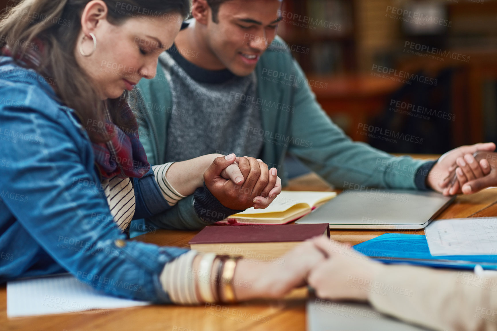 Buy stock photo Group, bible study or holding hands at table for prayer, gratitude or worship at tech. Religious people, spiritual gesture or meeting in library for learning, faith or trust in christian community