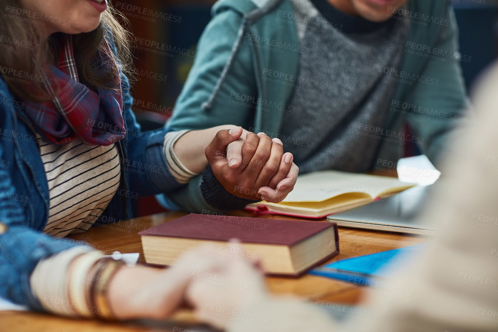 Buy stock photo People, bible study or holding hands at table for worship, gratitude or prayer at book. Religious group, spiritual gesture or meeting in library for learning, faith or trust in christian community