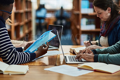 Buy stock photo Group, studying and learning in library for education, knowledge and scholarship at college or university. Students or people reading book and research or essay writing with free resources and laptop