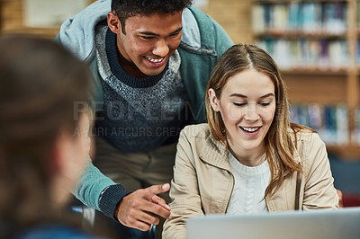 Buy stock photo Shot of university students working together on a laptop at campus