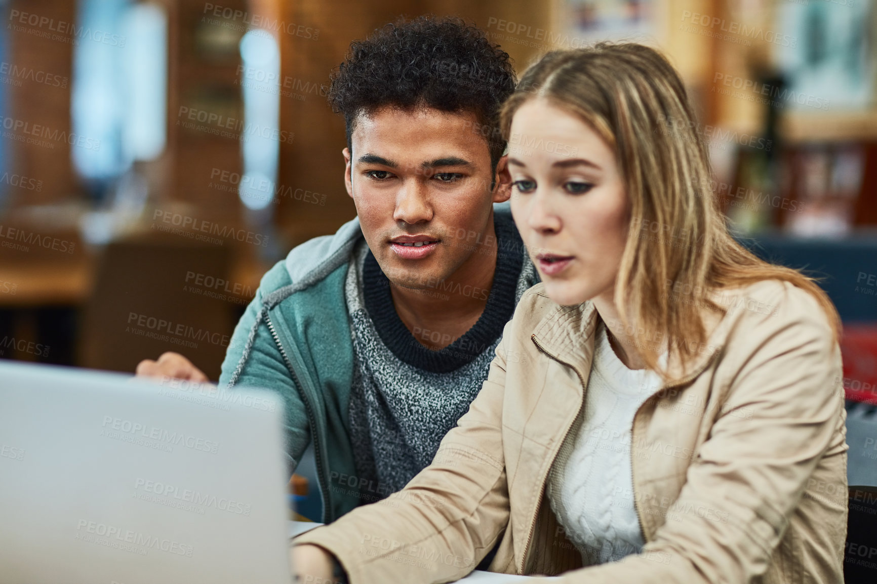 Buy stock photo Shot of two university students working together on a laptop at campus