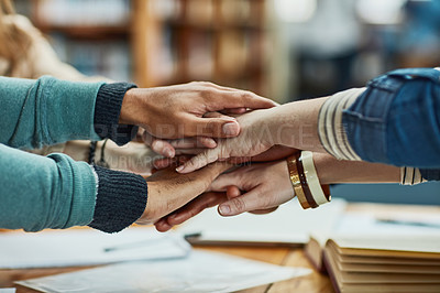 Buy stock photo Students, group and hands together in library for learning, knowledge and education goals, support or team work. People, circle and stack with school motivation, collaboration or faith for studying