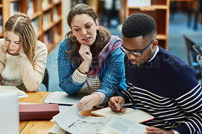 Buy stock photo Library, people and studying with book, page and reading for exam, woman and man in campus of college. Students, friends and teamwork for test, information and table with research and together