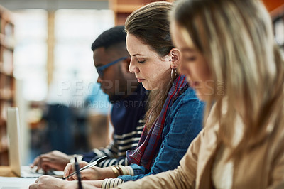 Buy stock photo Shot of a group of university students sitting in class at campus