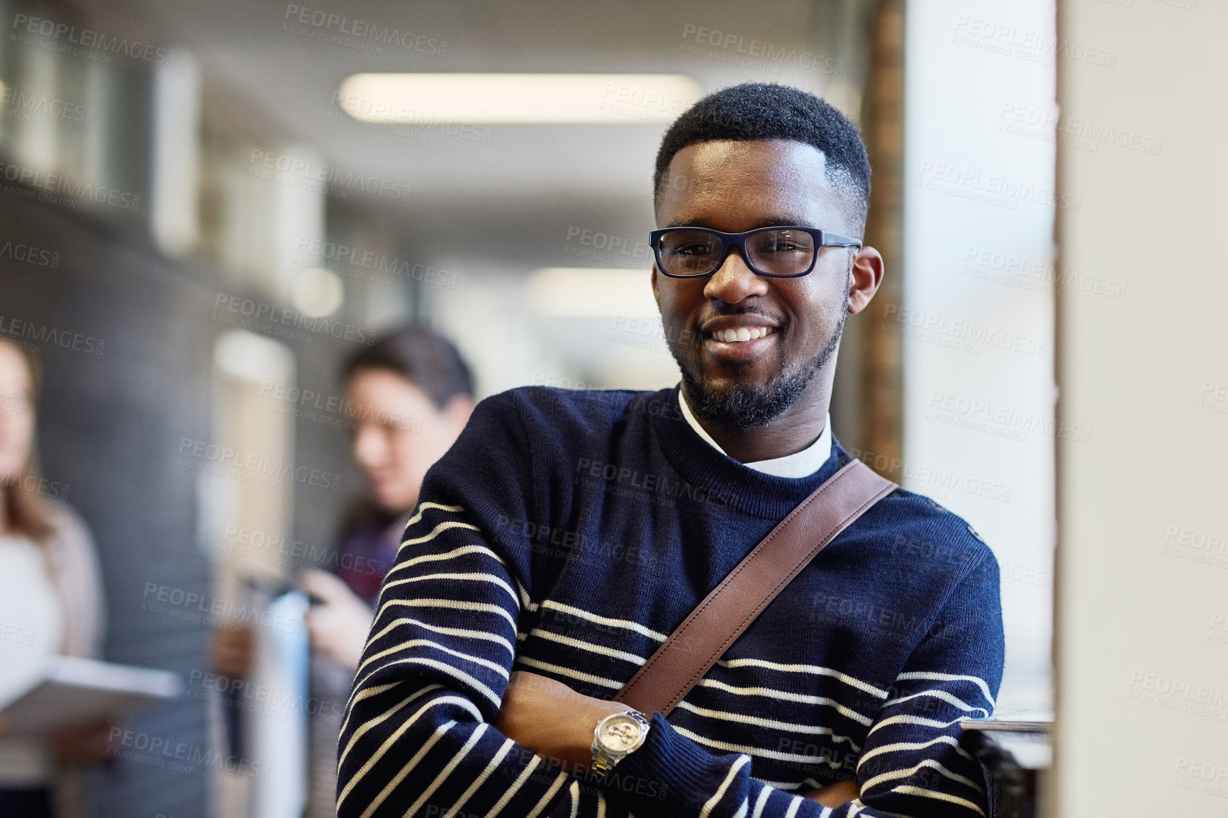 Buy stock photo Portrait of a university student standing in a corridor at campus