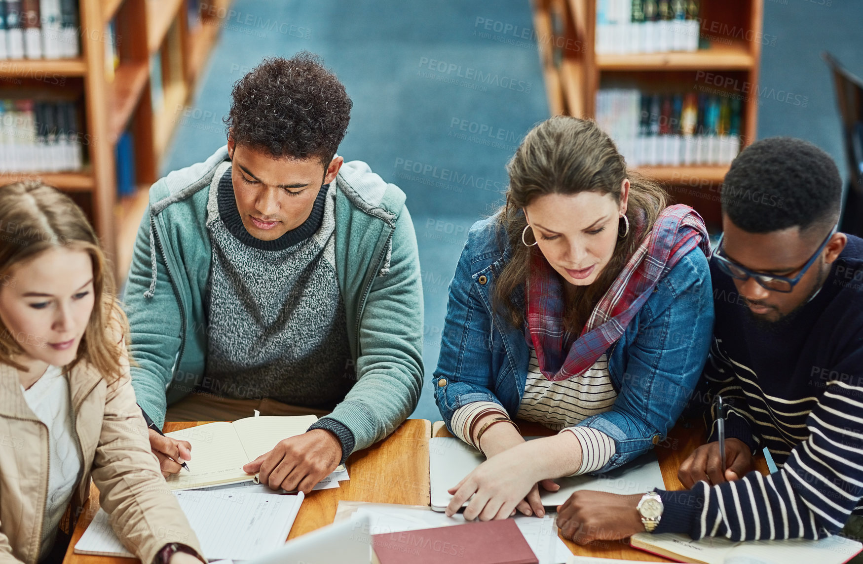 Buy stock photo Students, group and library with books for learning, research or together for education at college. Man, girl and friends with reading for collaboration, support or diversity for knowledge at campus