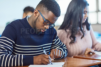 Buy stock photo Shot of university students working in class at campus
