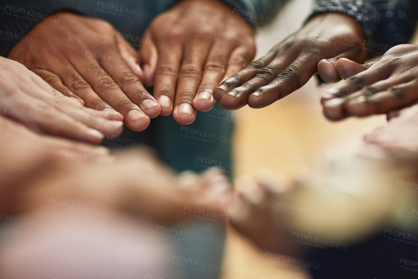 Buy stock photo Closeup shot of a group of university students joining their hands together in unity