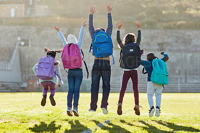 Buy stock photo Rearview shot of elementary school kids jumping outside