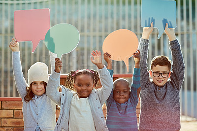 Buy stock photo Cropped shot of elementary school kids holding up speech bubbles outiside