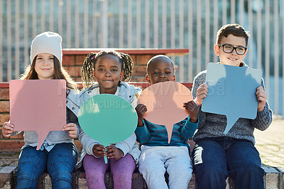 Buy stock photo Cropped shot of elementary school kids holding up speech bubbles outside