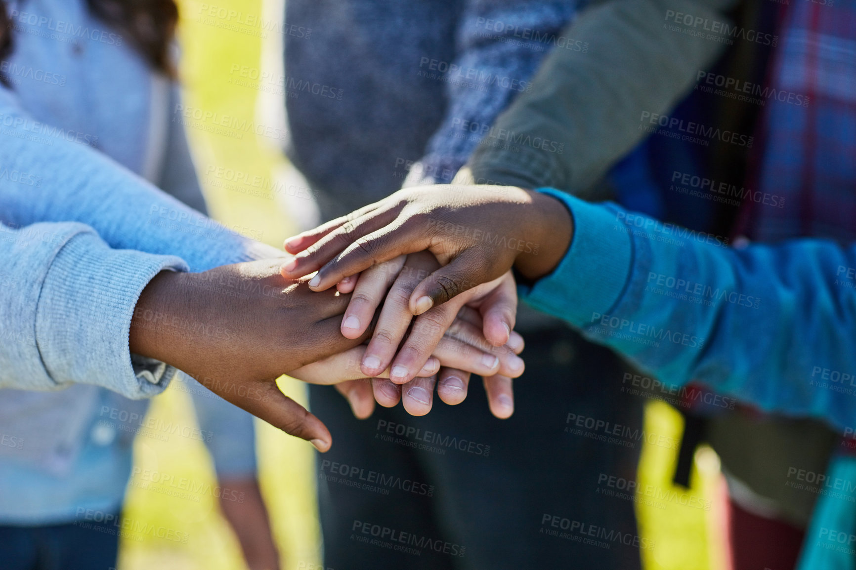 Buy stock photo Cropped shot of unrecognizable elementary school kids huddled together outside