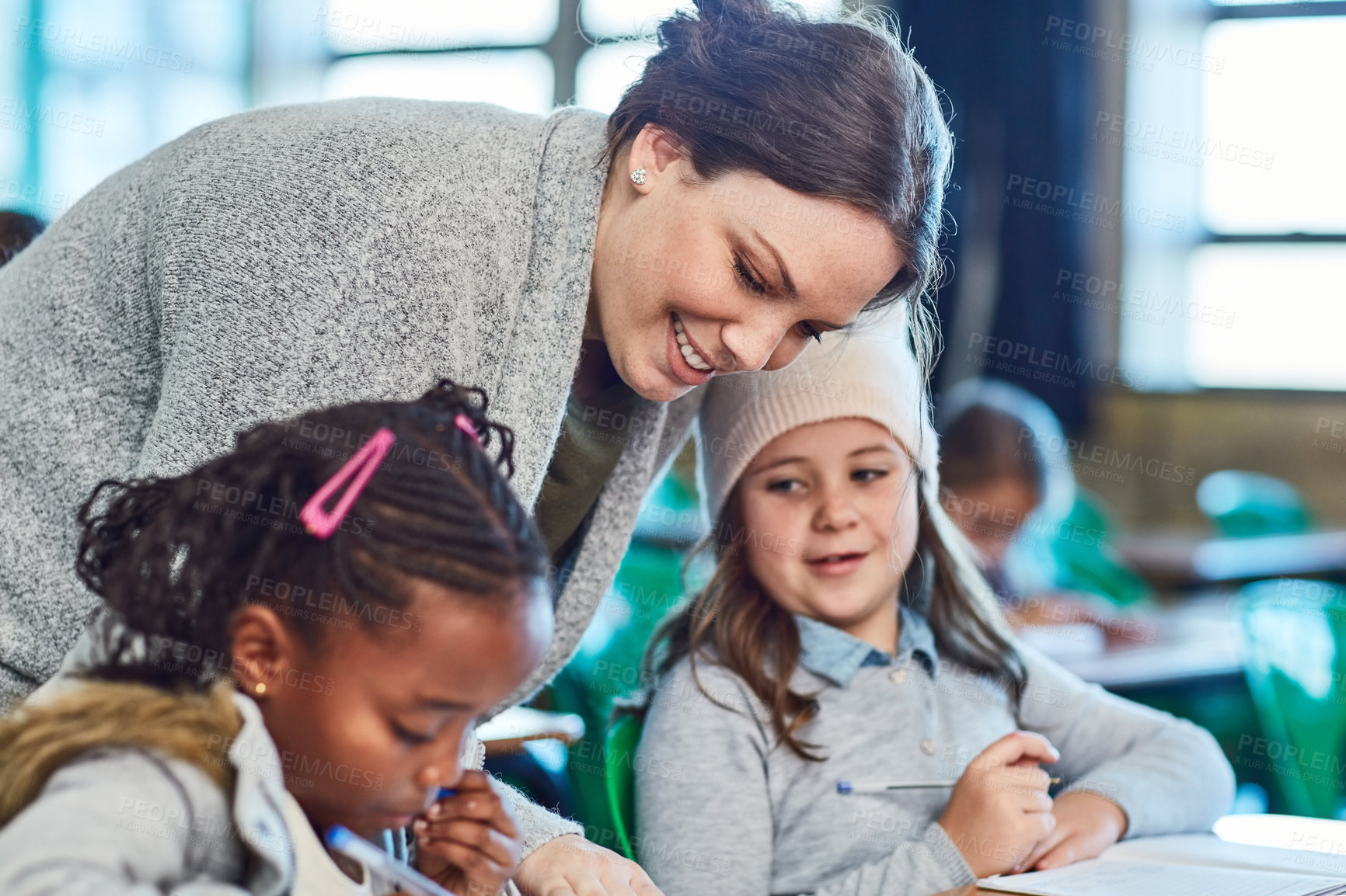 Buy stock photo Teacher, learning and help children in class writing in notebook for education, studying or knowledge. Kids, happy woman and students in lesson for assistance or development at elementary school