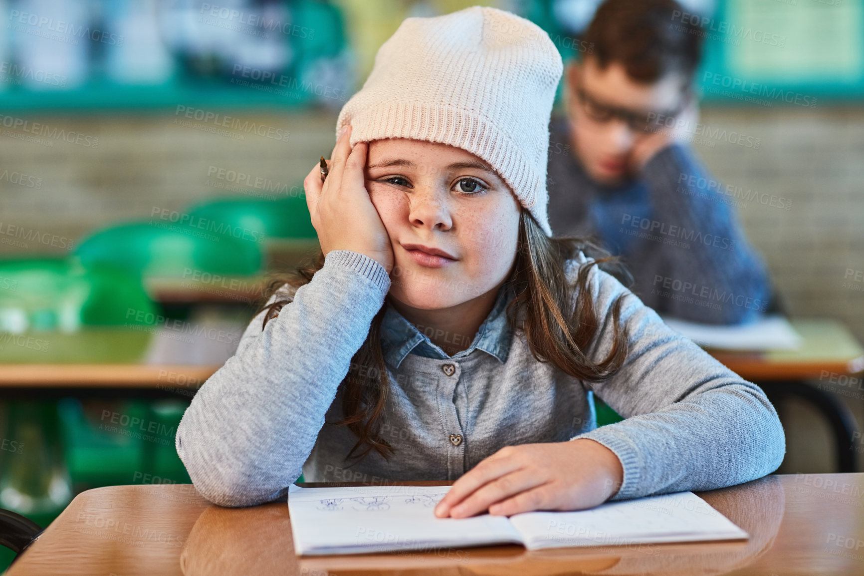 Buy stock photo Tired, student and portrait of bored kid in classroom for education, learning and lazy. Child, fatigue and face of girl in elementary school with adhd, exhausted or low motivation with stress and sad