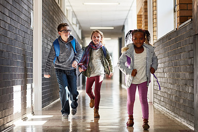 Buy stock photo Cropped shot of elementary school kids running in the corridor at school
