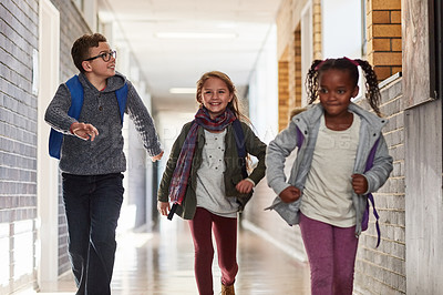Buy stock photo Cropped shot of elementary school kids running in the corridor at school