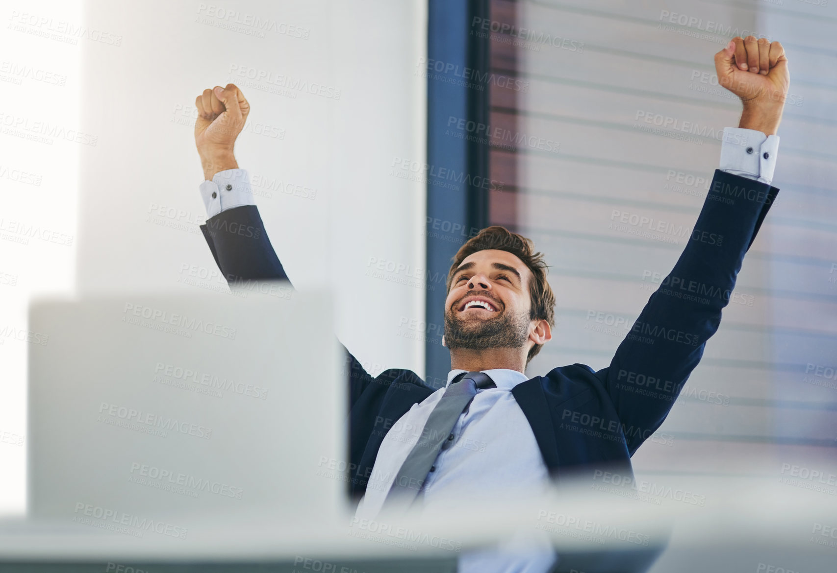 Buy stock photo Businessman, winner and success fist in office for celebration, promotion and achievement of goal. Male person or salesman and deal or target with smile, hands up and computer with good news