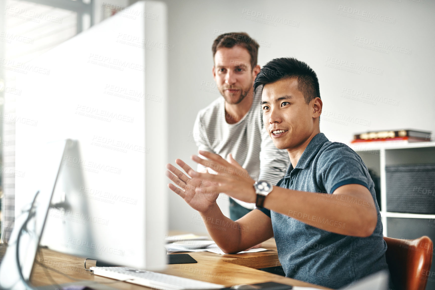 Buy stock photo Cropped shot of two designers working together on a project in an office