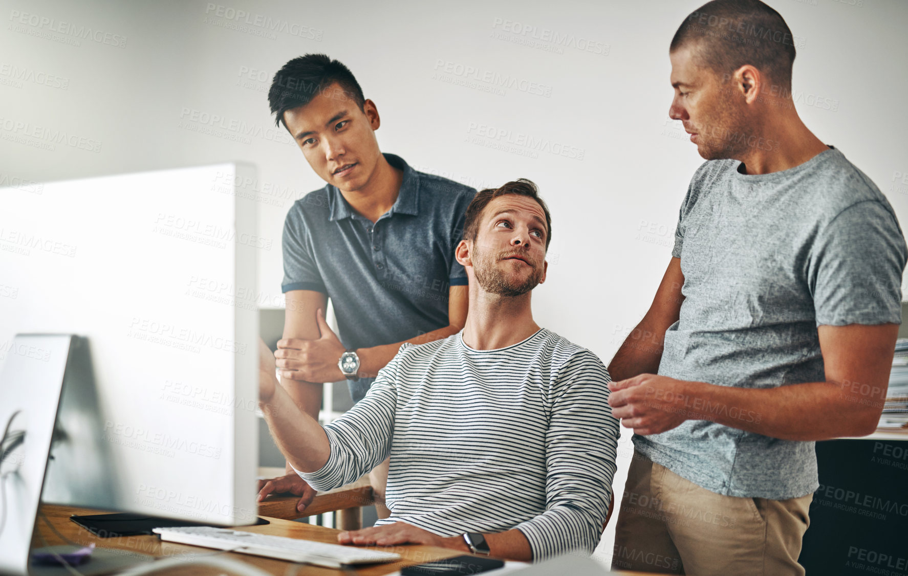 Buy stock photo Cropped shot of three designers working together on a project in an office