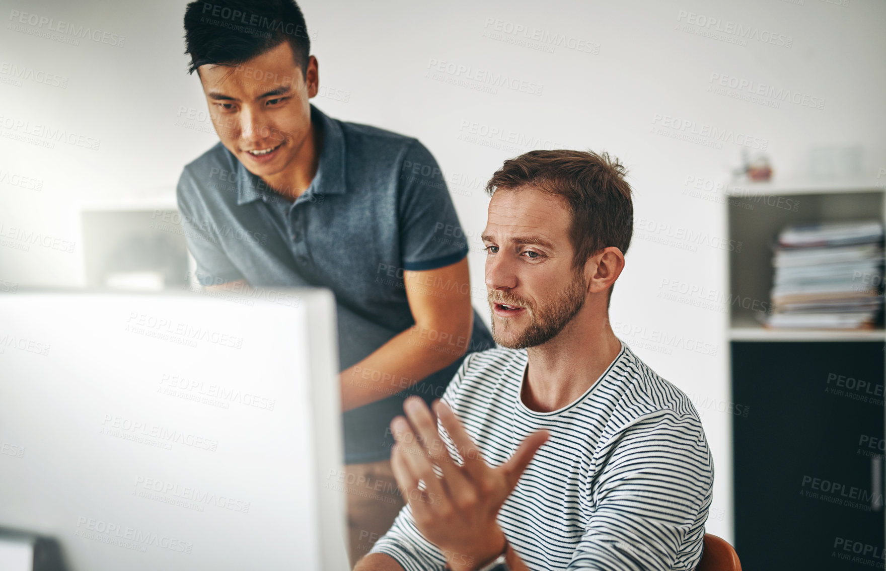 Buy stock photo Cropped shot of two designers working together on a project in an office