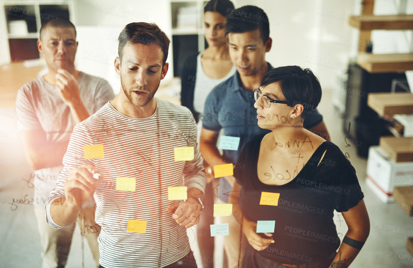 Buy stock photo Manager, leader or boss talking and planning in a presentation or workshop seminar with sticky notes in a boardroom. Business man discussing and brainstorming with colleagues and coworkers from above