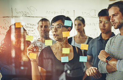 Buy stock photo Business people planning ideas on a glass board thinking, brainstorming and working on strategy for a project. Smart, busy and organized workers doing work schedule brainstorm with sticky notes
