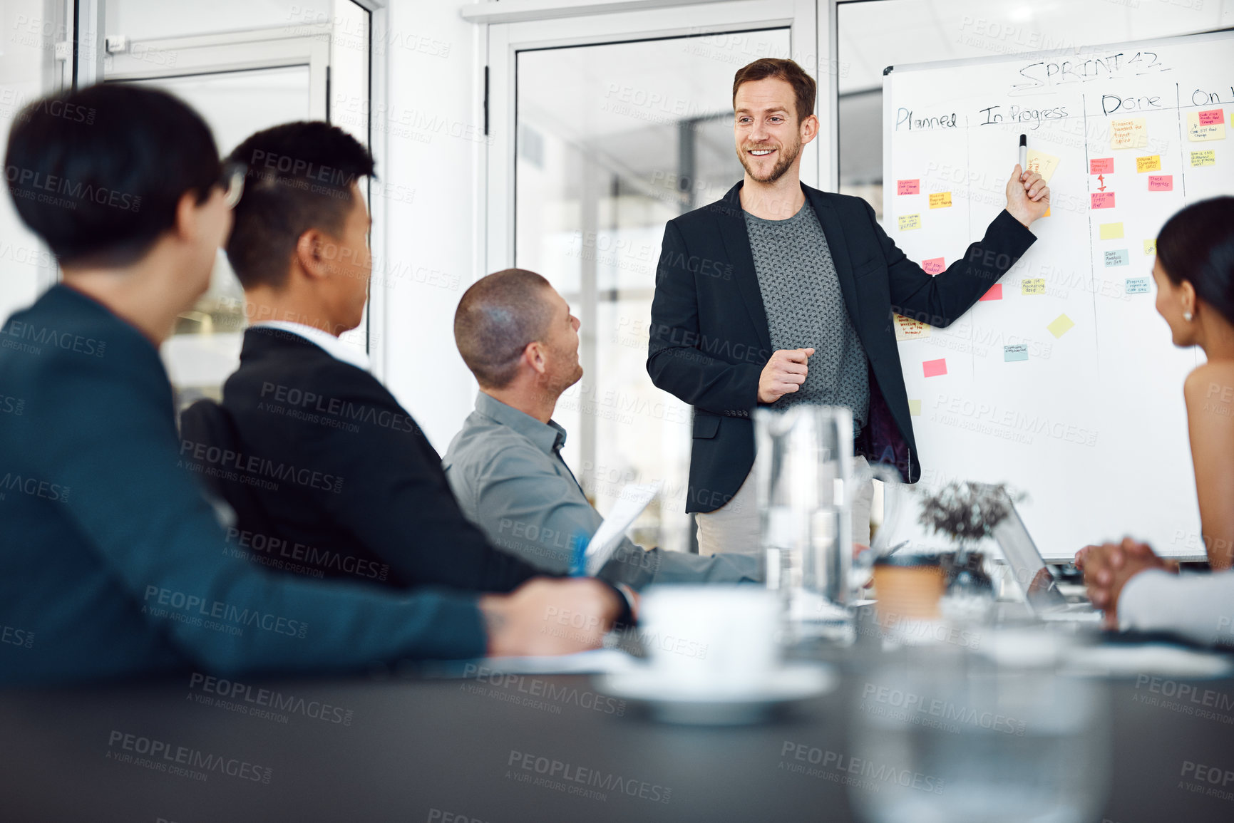 Buy stock photo Man, presentation and sticky notes on whiteboard for meeting, timeline and brainstorming strategy in office. Speaker, workshop and group training in boardroom for goals, collaboration and instruction