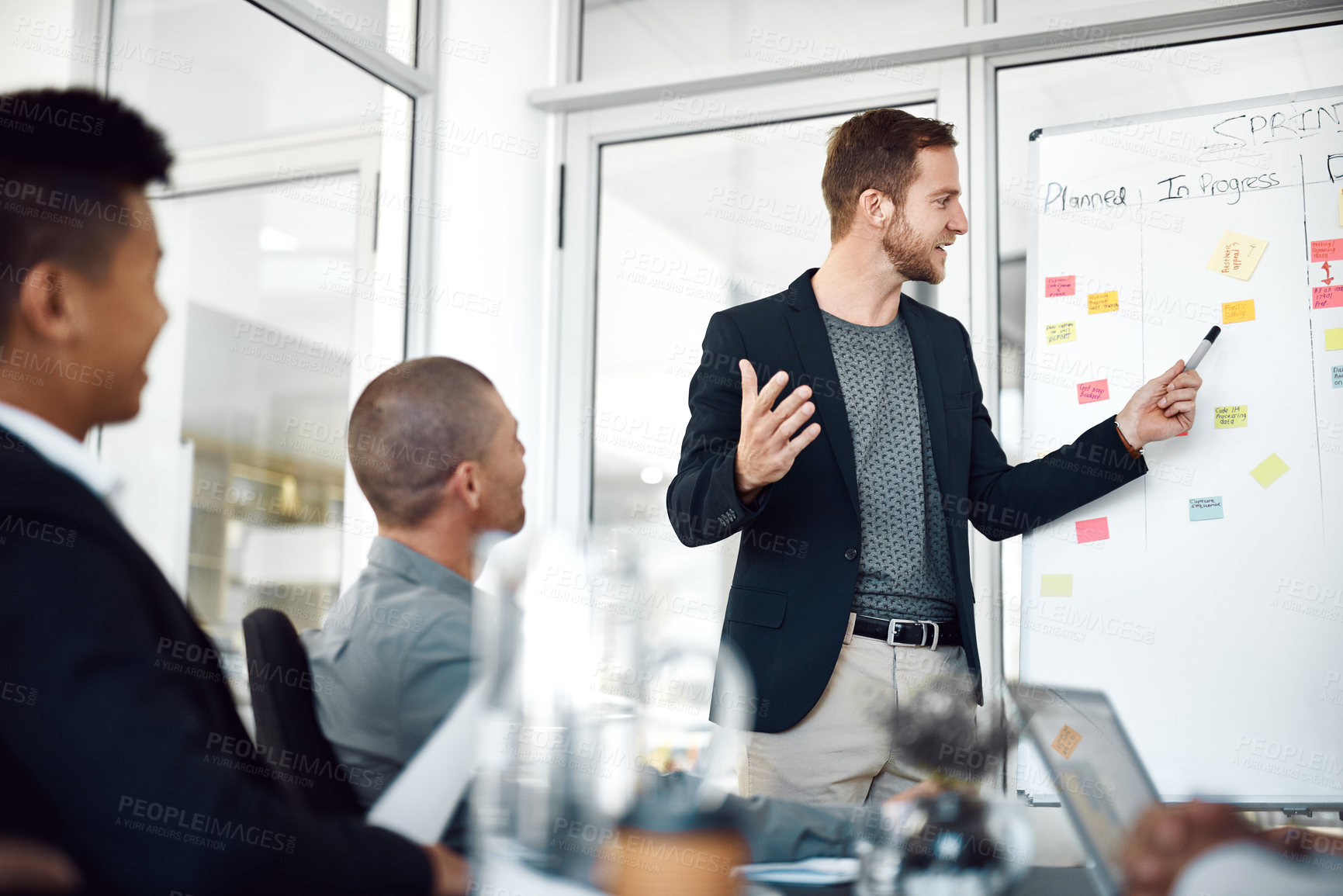 Buy stock photo Employees, whiteboard and sticky notes for meeting in office, planning and boardroom for progress. Man, mentor and speaking to staff on productivity in workplace, charts and brainstorming project