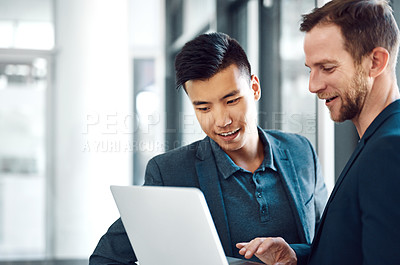 Buy stock photo Shot of colleagues using a laptop in the office