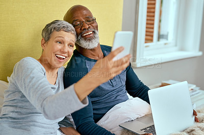 Buy stock photo Shot of a senior married couple taking a selfie at home