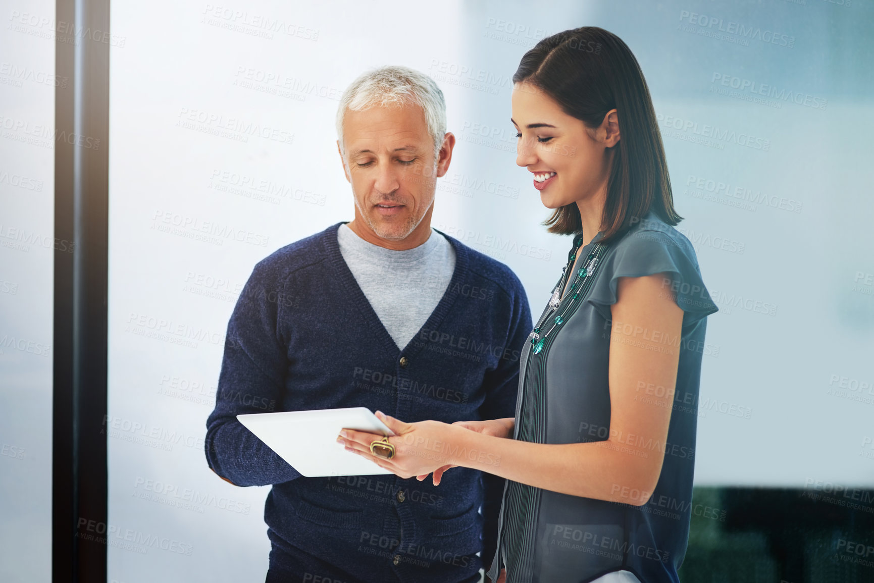Buy stock photo Businessman, tablet and discussion with colleague for research, data or online browsing at office. People or employees talking with technology in conversation or communication on project at workplace
