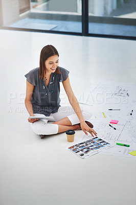 Buy stock photo High angle shot of an attractive young businesswoman working on the floor in her office