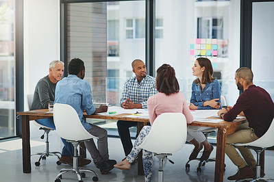 Buy stock photo Full length shot of a group of businesspeople sitting in the boardroom during a meeting