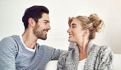 Buy stock photo Cropped shot of an affectionate young couple relaxing at home