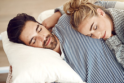 Buy stock photo Cropped shot of young couple having a nap together on their sofa at home