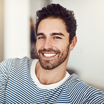 Buy stock photo Shot of a young man sitting at home