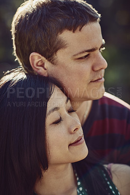 Buy stock photo Shot of a young couple spending quality time together outdoors