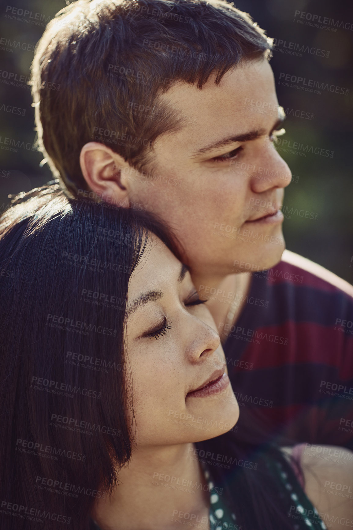 Buy stock photo Happy, love and couple hug in park for bonding, loving relationship and relax together outdoors. Dating, interracial and face of man and woman embrace for affection, commitment and romance in nature