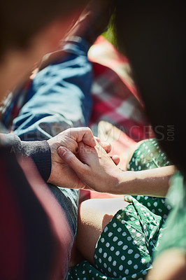 Buy stock photo Couple, holding hands and picnic at park with care, love and bonding in spring sunshine. Man, woman and support with connection, holiday or relax outdoor with blanket, comfort and trust in nature