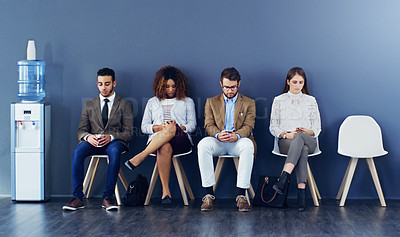Buy stock photo Full length shot of four businesspeople sitting in line for an interview