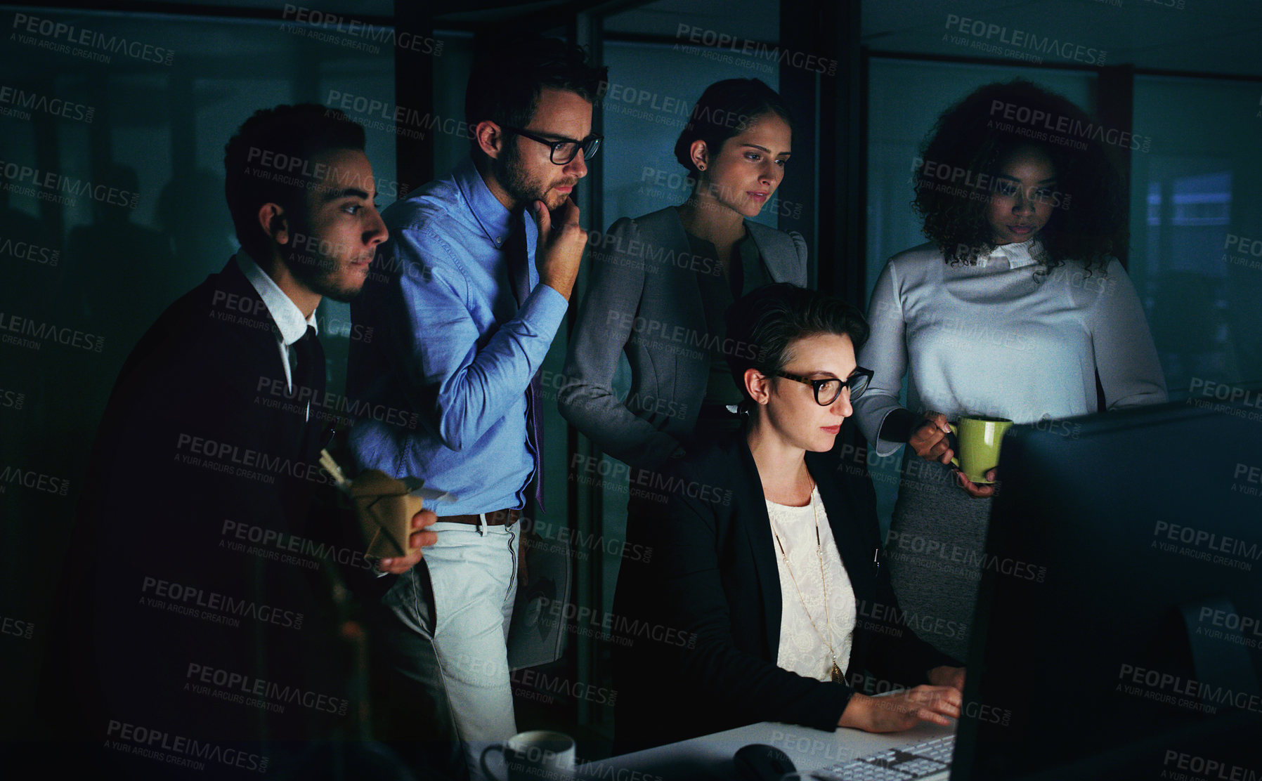 Buy stock photo Cropped shot of a diverse group of businesspeople gathered around a single computer in their office