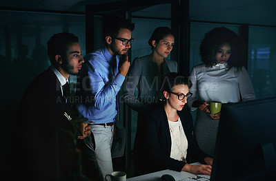 Buy stock photo Cropped shot of a diverse group of businesspeople gathered around a single computer in their office