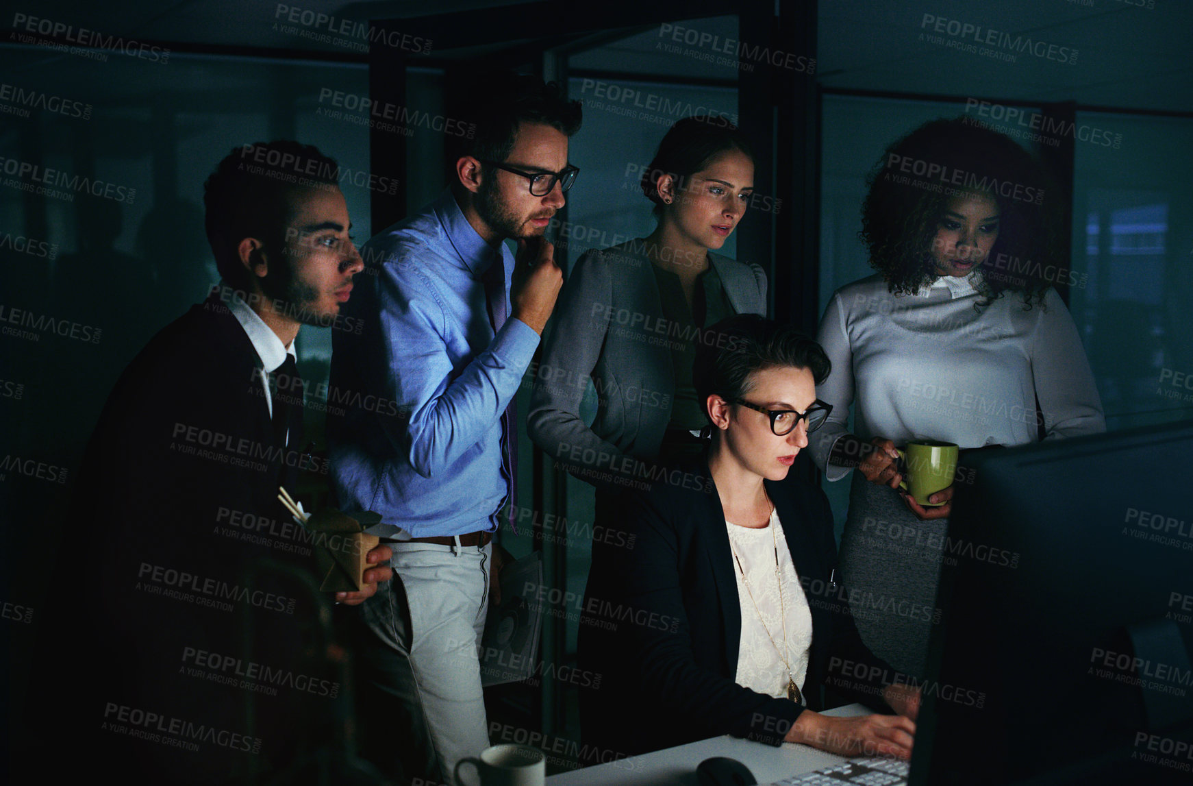 Buy stock photo Cropped shot of a diverse group of businesspeople gathered around a single computer in their office