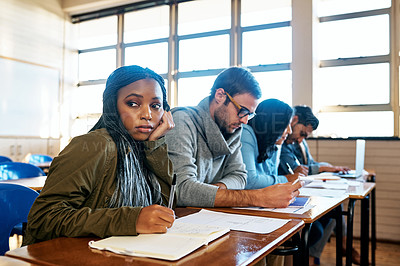 Buy stock photo Cropped shot of an attractive young university student looking bored while sitting in class