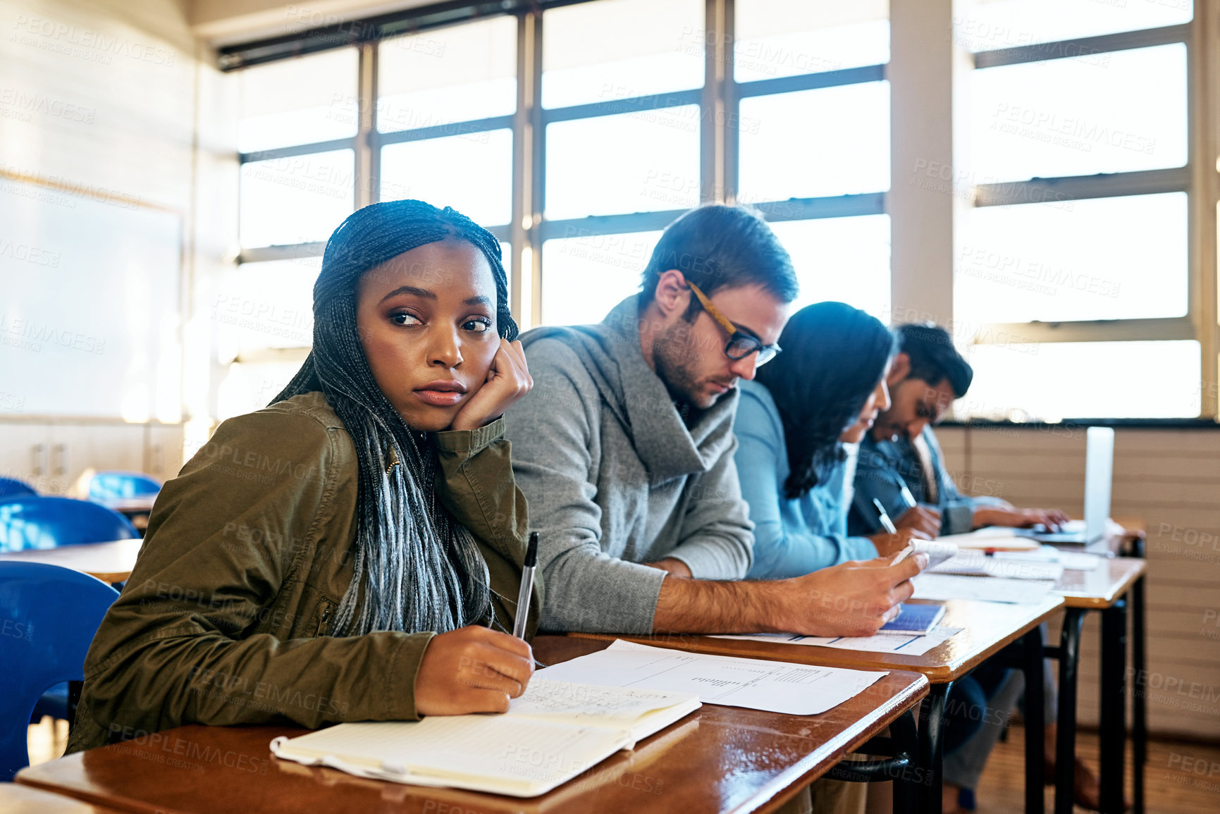 Buy stock photo University, student and woman stress in class from exam, test or project at desk with anxiety. Worry, campus and notebook with fear and disappointed from education and studying fail in classroom  