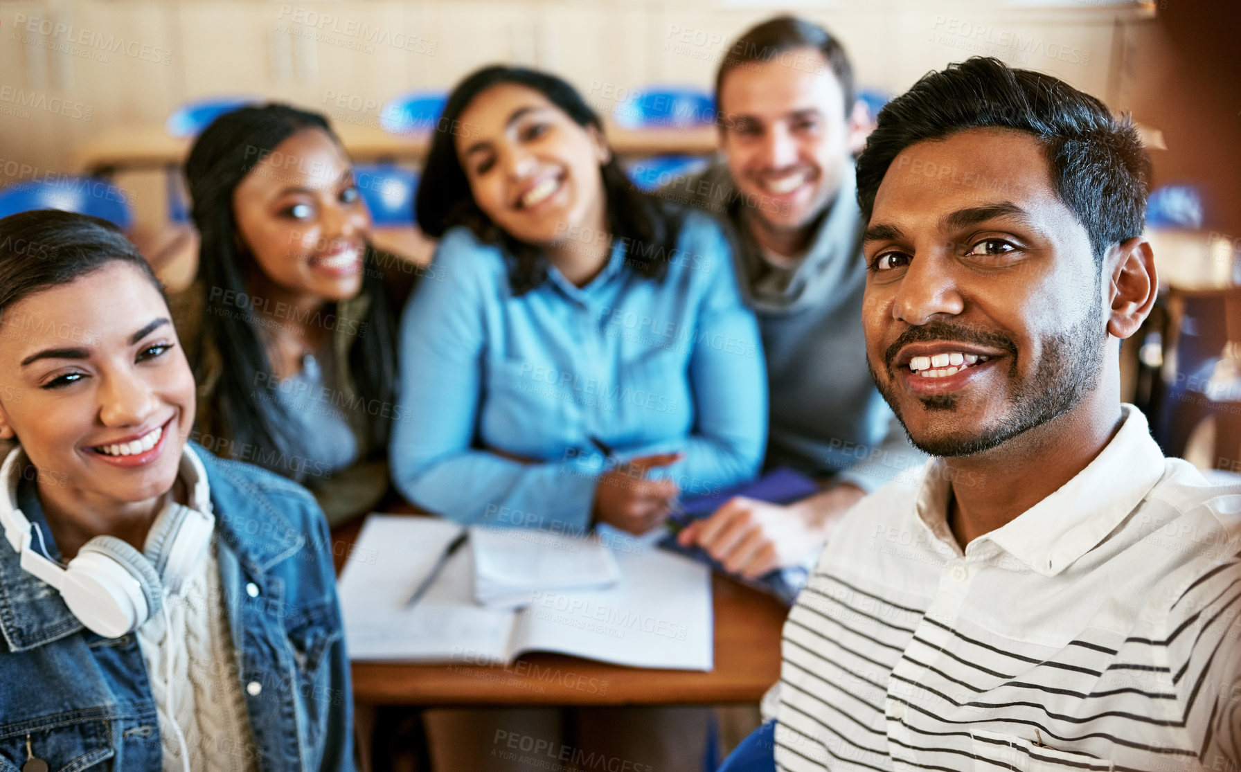 Buy stock photo Cropped portrait of a group of young university students sitting in class