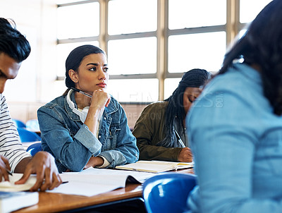 Buy stock photo Cropped shot of an attractive young university student looking thoughtful while sitting in class