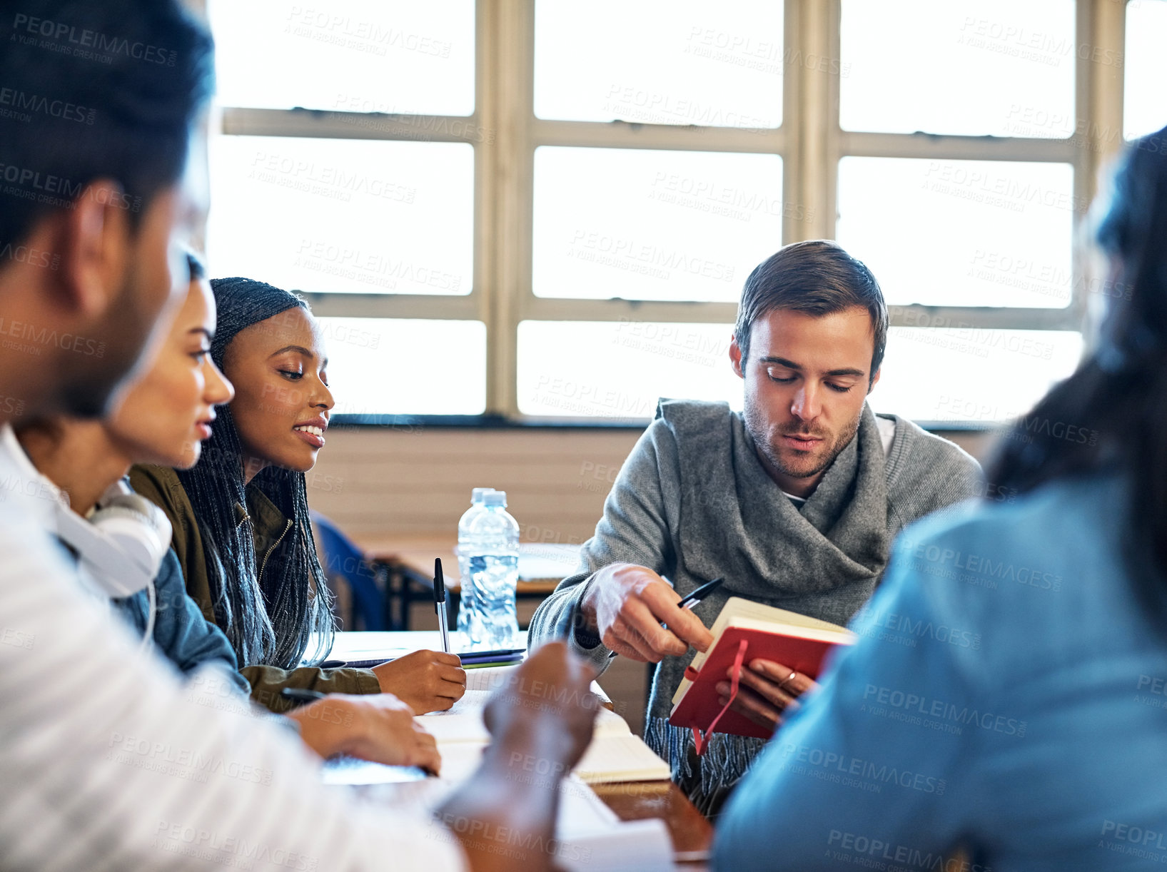 Buy stock photo Learning, students and classroom for group assignment with education on teamwork and collaboration at college. Diversity, classmates and people with studying for exams, assessment and test on campus