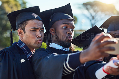 Buy stock photo Shot of two students taking a selfie together on graduation day