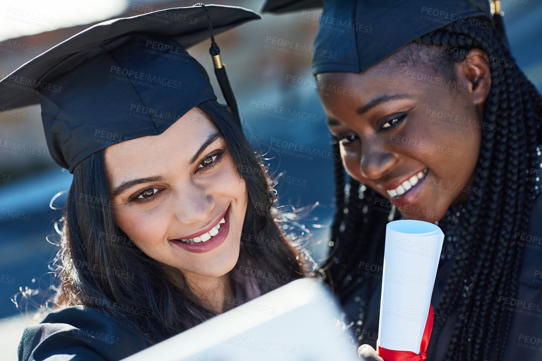 Buy stock photo Shot of two students taking a selfie together on graduation day